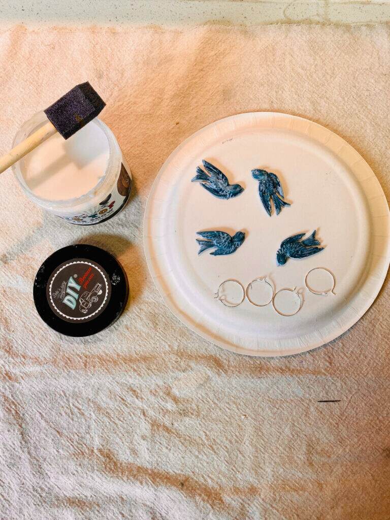 Applying Top Coat to painted birds.