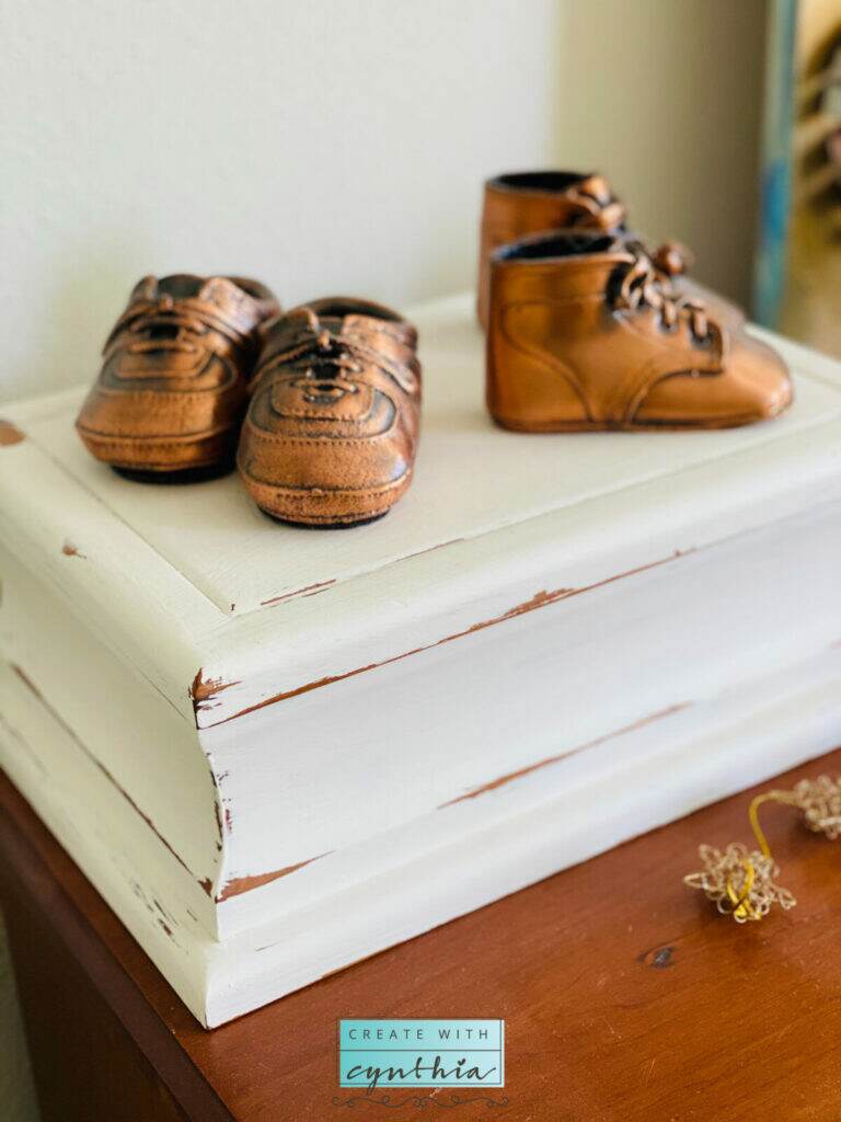 Copper shoes on a painted box.