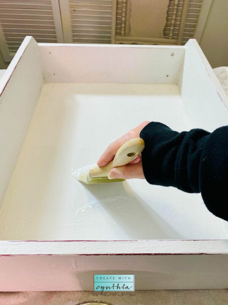 Painting the top coat on the pet bed.