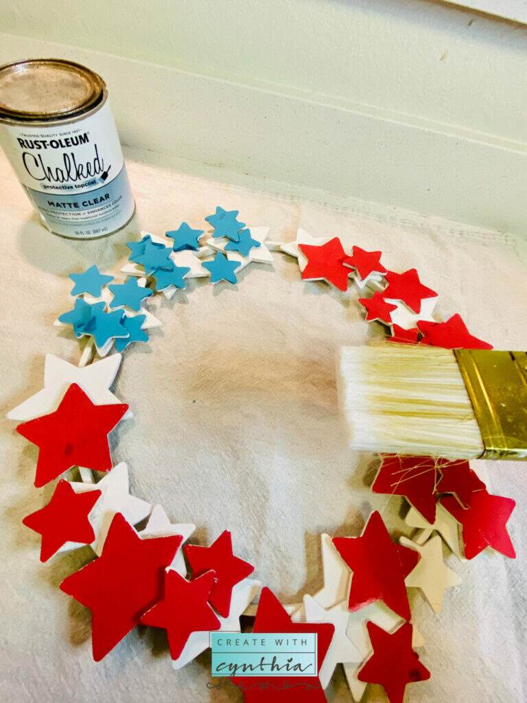 Applying top coat to star wreath